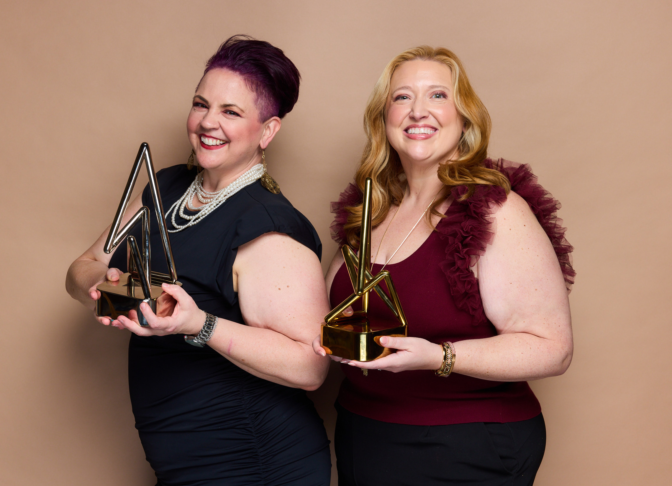 Kim Carlos and Kat Carter with their podcast awards